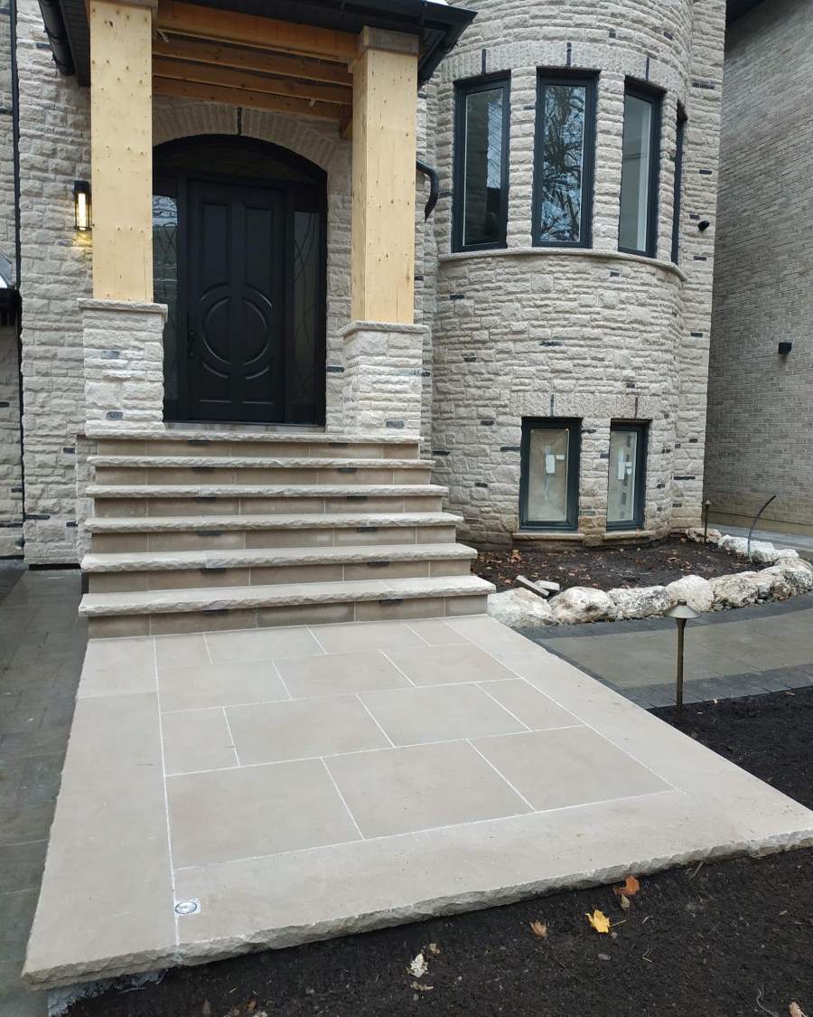 Natural stone porch landing and steps with clean joints and a chiselled edge finish
