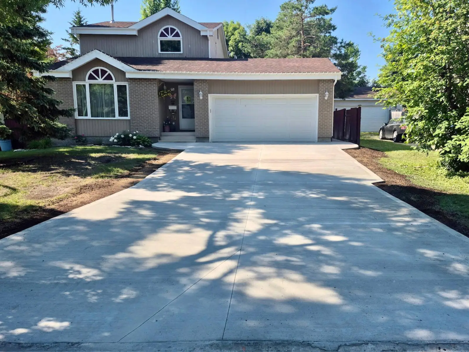 Poured concrete driveway with smooth uniform finish and control joints